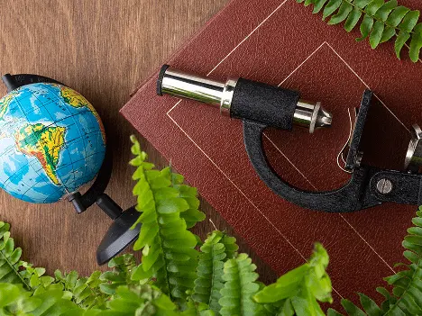 Social science study materials including globe and microscope for ACT online coaching reading section